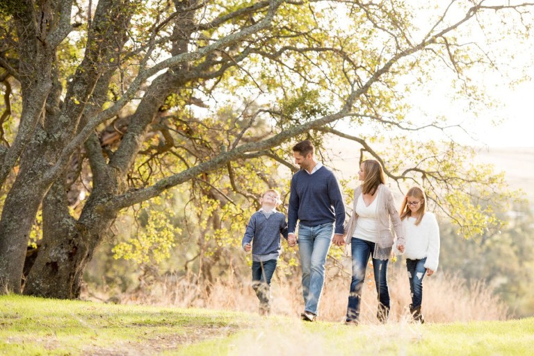 A family walks in the woods for holiday photos