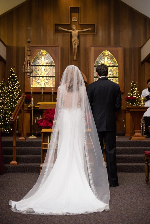 A bride and a groom standing at the alter at St. Patrick's Church in Placerviile